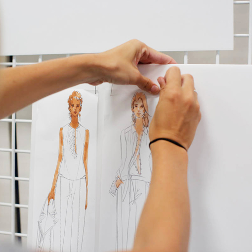 Designer placing sketches on a whiteboard 