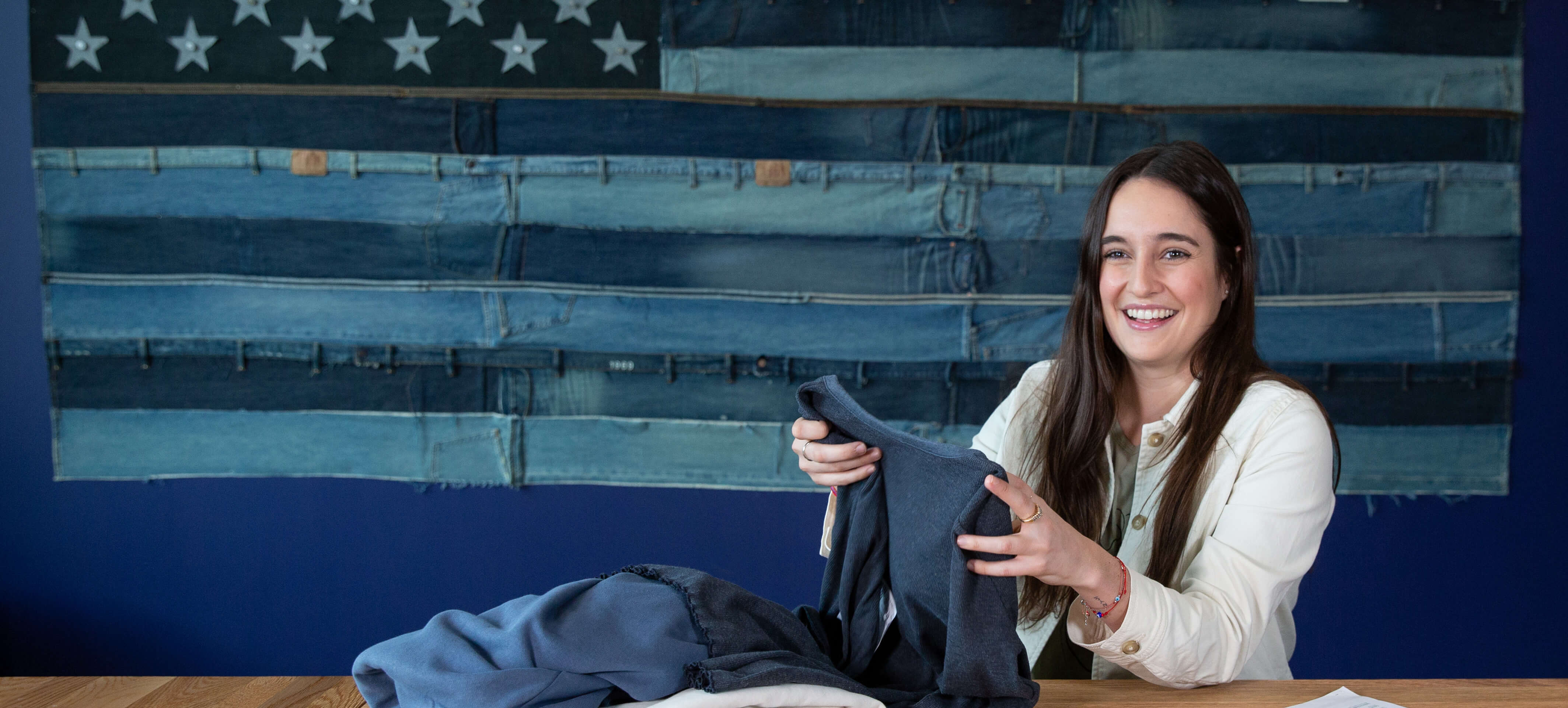 woman folding a shirt on a table